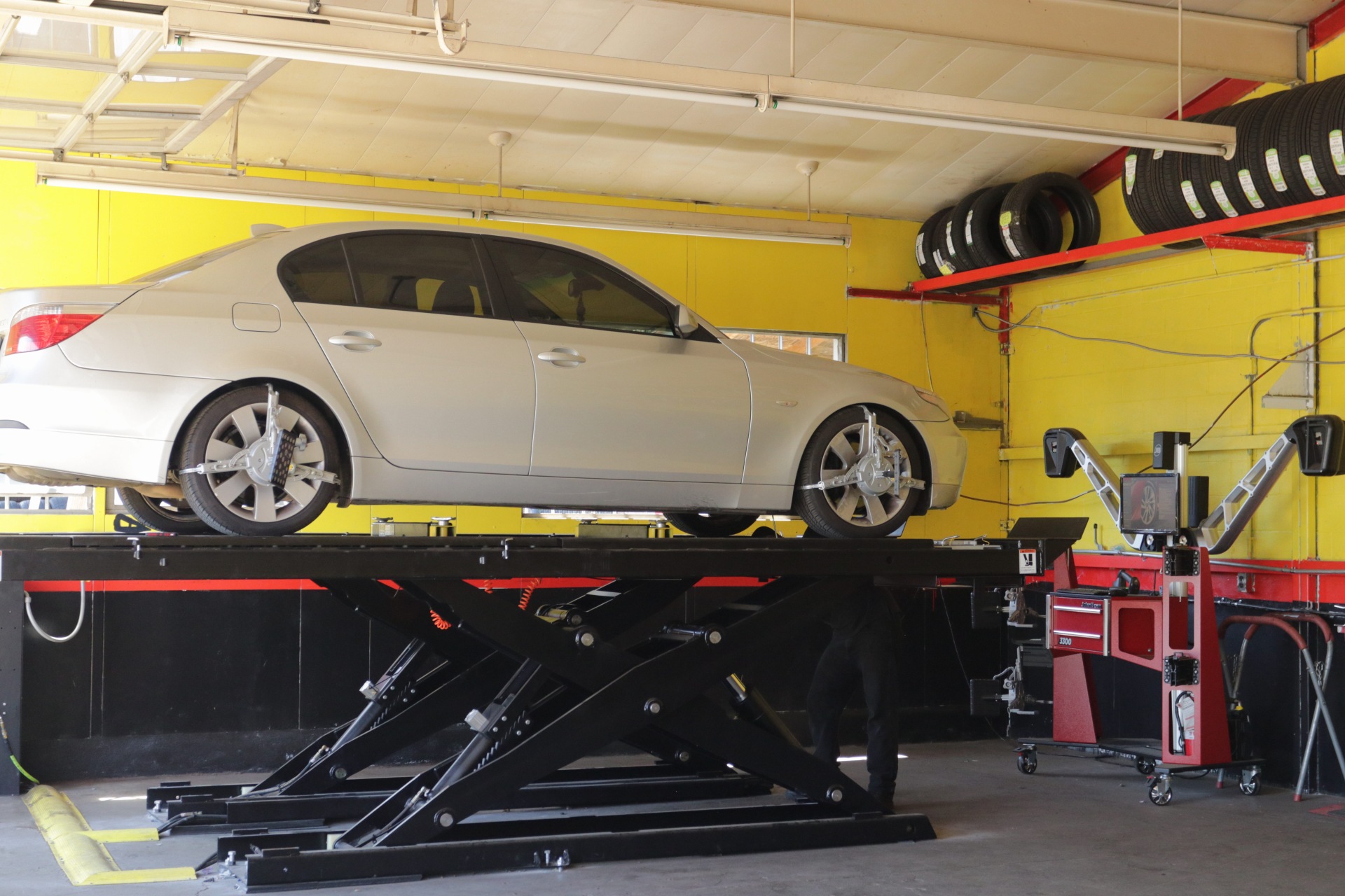 A car raised on the alignment lift inside the Portland Tire Shop workshop